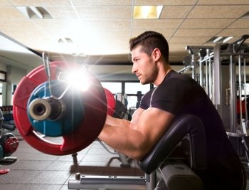 biceps preacher bench arm curl workout man at fitness gym