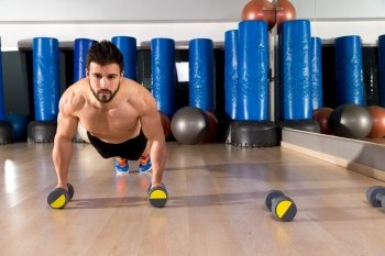 Dumbbells push-ups pushups beard man at fitness gym workout