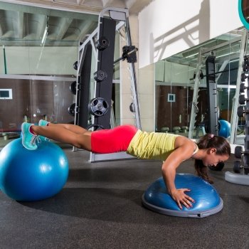 swiss ball bosu push up woman blue fitball workout at gym