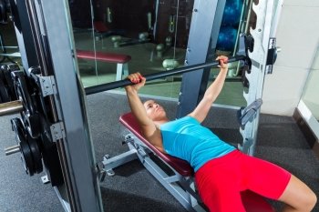 Bench press woman on flat multipower Smith machine workout exercise at gym