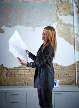 Architect woman working holding plan paper at office