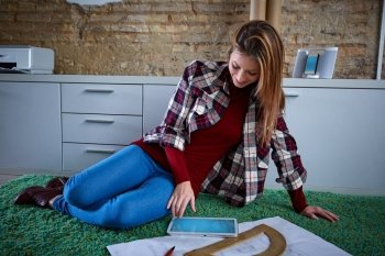 Architect student woman doing homework at home carpet
