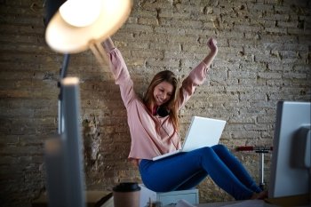 Excited happy young woman at office open arms with laptop