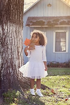 Kid toddler girl with autumn leaf playing outdoor park latin ethnicity