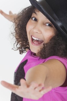 Studio shot of a beautiful happy young mixed race girl laughing and singing wearing a black top hat