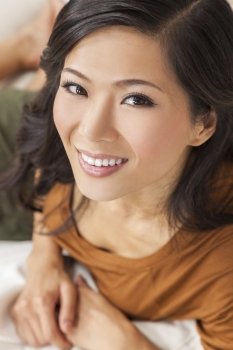 A beautiful young Chinese Asian Oriental woman with a wonderful toothy smile 