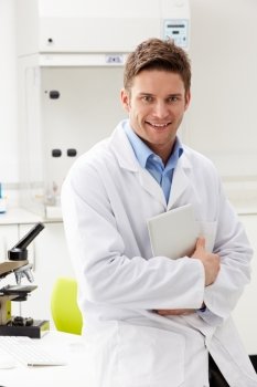 Portrait Of Scientist With Clipboard In Laboratory
