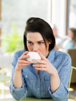 Woman Enjoying Drink In Cafe