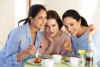 Three Women Having Snack In Cafe