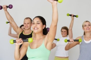 Group Of People Exercising In Dance Studio With Weights