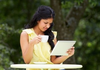 Teenage Girl Using Digital Tablet In Outdoor cafe