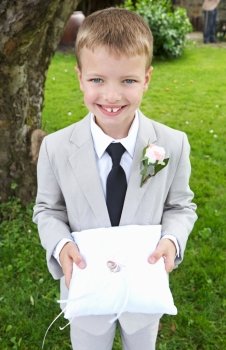 Page Boy Carrying Wedding Ring On Cushion
