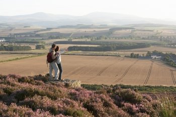 Couple Admiring View On Countryside Walk