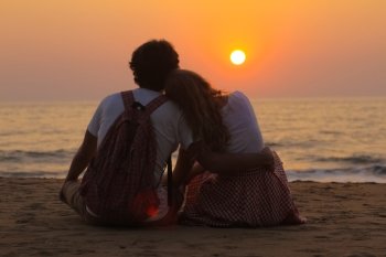Young Couple is Watching Sunset
