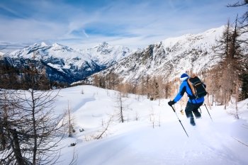 Winter sport: man skiing in powder snow. Val D’Aosta, italian Alps, Europe.