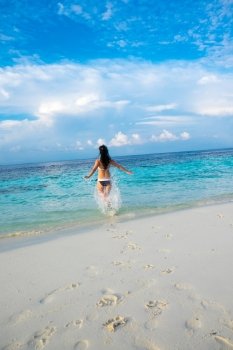 Beach vacation. Girl and tropical beach in the Maldives.