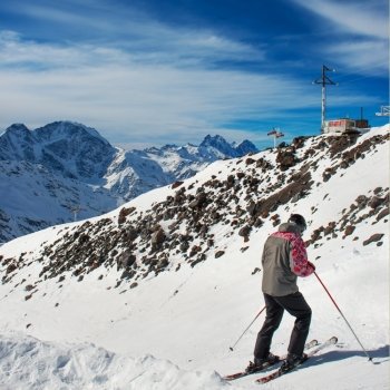 Skier at ski resort. Snow in the mountains