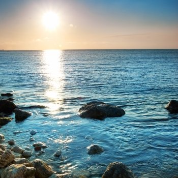 Beautiful sea sunset. Coast with stones and rocks