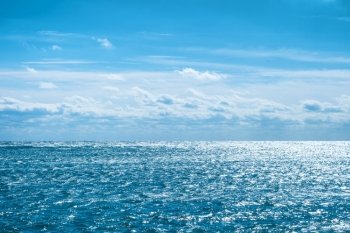 Blue sea with sky and clouds. Water natural background