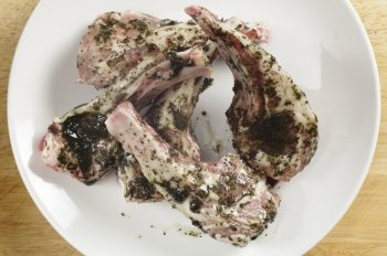 Lamb chops coated with a mint marinade read to go on a  barbecue grill