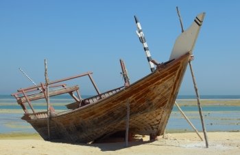 A beached dhow at Wakrah, south of Doha, Qatar. The vessel seems to have been abandoned long ago and is little more than a wreck now