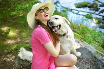 Attractive woman playing with friendly dog