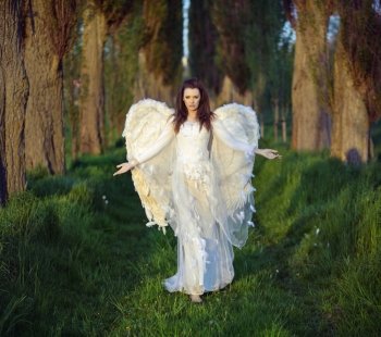 Marvelous lady-angel in the forest