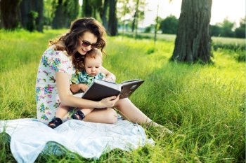 Brunette mother reading a fairy tale for her kid
