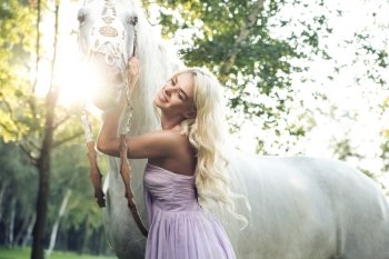 Satisfied woman hugging the white horse