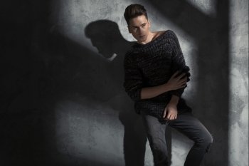 Young slim man wearing trendy woolen sweater