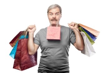 surprised mature man holding shopping bags isolated on white background