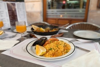 Paella on the plate in street cafe of Barcelona, Spain
