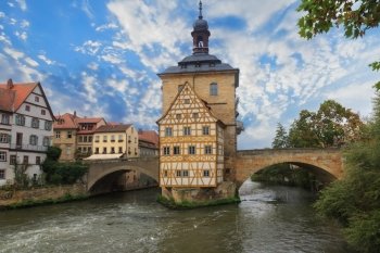 Obere bridge (brucke) and Altes Rathaus and cloudy sky in Bamberg, Germany
