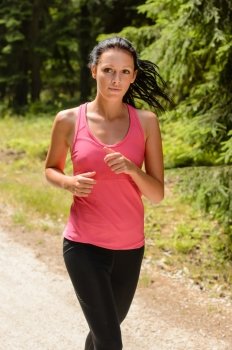 Woman jogging outdoor running on sunny day countryside path