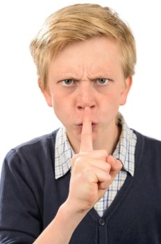 Angry boy with finger on lips isolated over white background