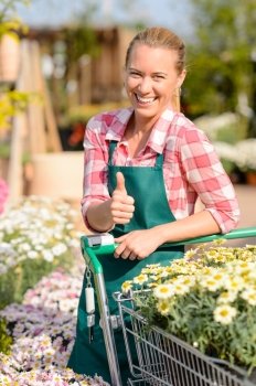Garden center smiling woman with colorful potted flowers thumb up