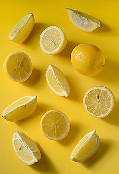 Fresh lemon slices on yellow background