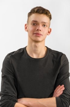 portrait of a male caucasian teenager on gray background. portrait of a teenager