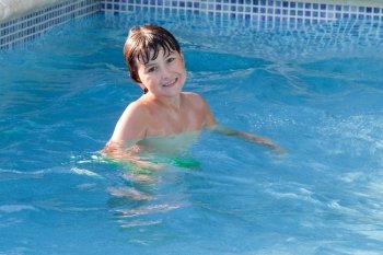 Adorable little boy swiming in the swimming-pool