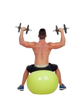 Strong man practicing exercises with dumbbells sit on a ball isolated on white background