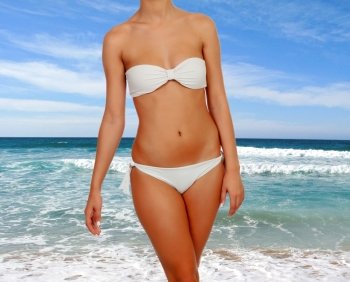 Beautiful female body with white bikini in the beach