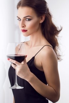 young gorgeous brunette with glass of red wine