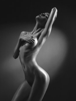 Elegant beautiful nude lady on black background 
