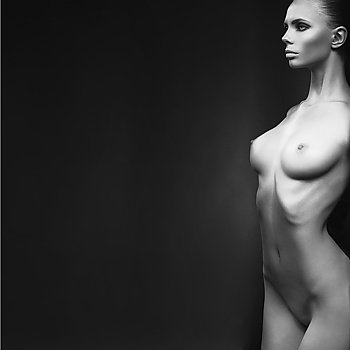 Fashion portrait of nude elegant lady on black background