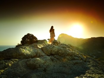Woman silhouette at sunset in mountains. Crimea landscape