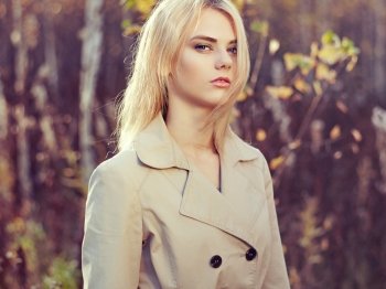 Portrait of young beautiful woman in autumn cloak. Fashion photo. Blonde girl. Perfect make-up