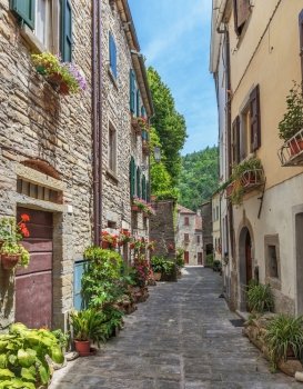 Narrow old street with flowers in Italy