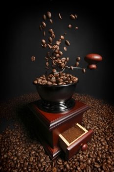 Vintage manual coffee grinder with falling coffee beans 