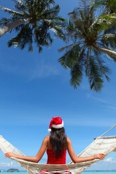Christmas vacation. Christmas vacation - woman in santa hat on the beach in hummock