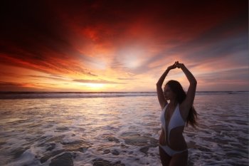 Happy woman posing on the beach at sunset, Bali, Seminyak, Double six beach